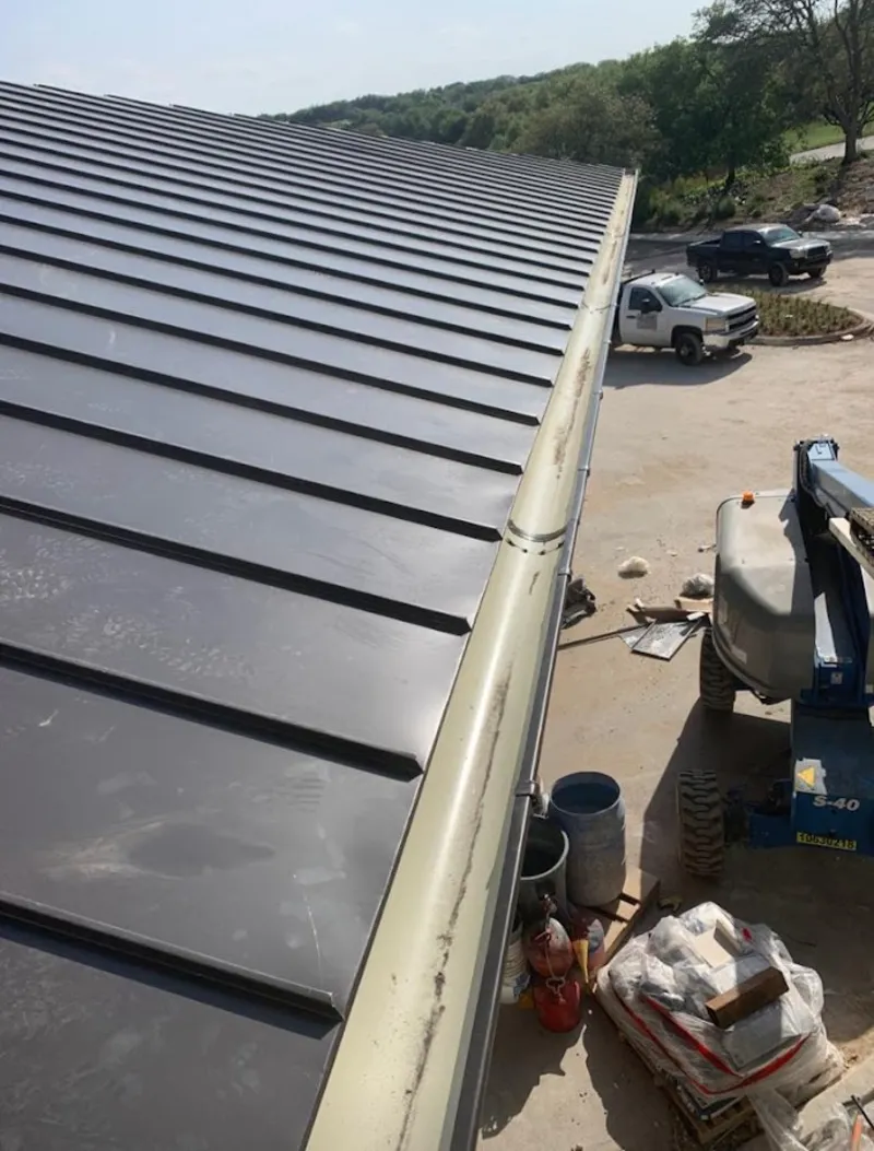 Standing seam panel and gutter detail on a metal roofing jobsite in Pleasanton